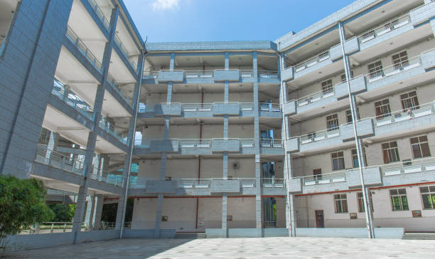 istock Modern school building on the university campus, surrounded by floors, with a square in the middle, sunny in summer 1031223994