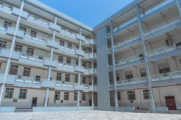 istock Modern school building on the university campus, surrounded by floors, with a square in the middle, sunny in summer 1031223996