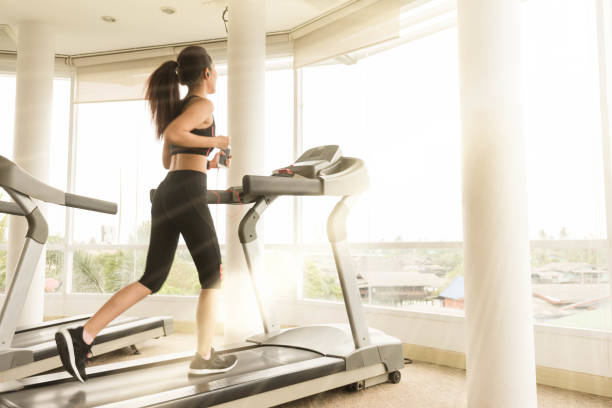 istock Teenage girl exercise on running machine 1031224406