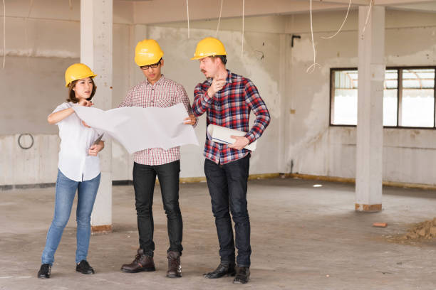 istock three construction engineers working together in side buiding planning for the renovation 1031224496