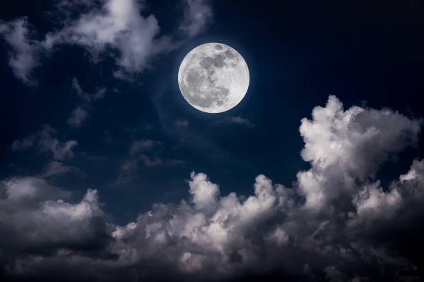istock Night sky with bright full moon and cloudy, serenity blue nature background. 1031227690