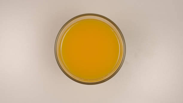 istock TOP VIEW: Fresh orange juice in a glass on a table 1031230180
