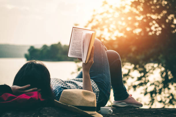 istock Women read books in quiet nature, concept read a books. 1031232648