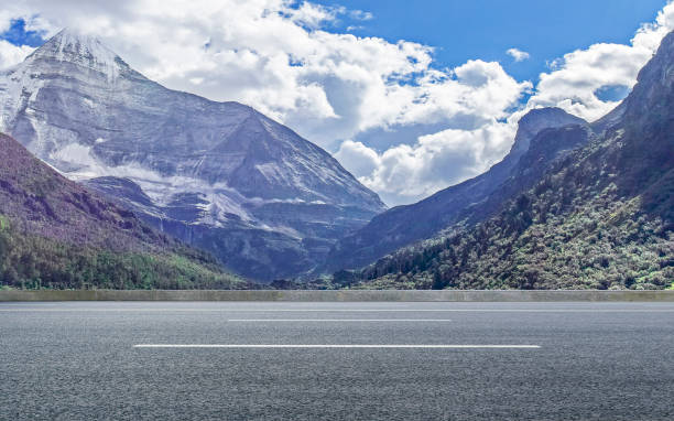 istock Outdoor highway and distant mountains, blue sky and white clouds, on sunny summer day 1031232854