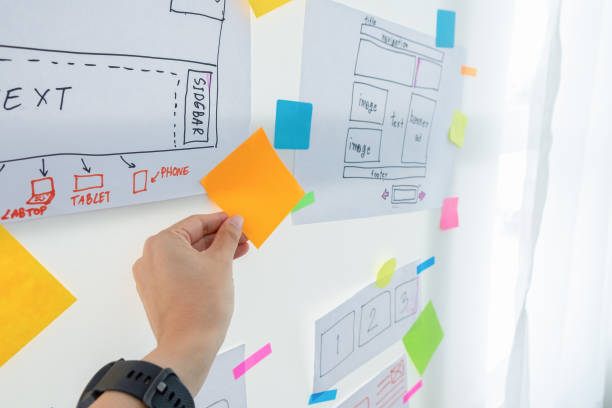 istock Woman hand holding the orange sticky note. The concept for Web designer brainstorm process in office. 1031235206