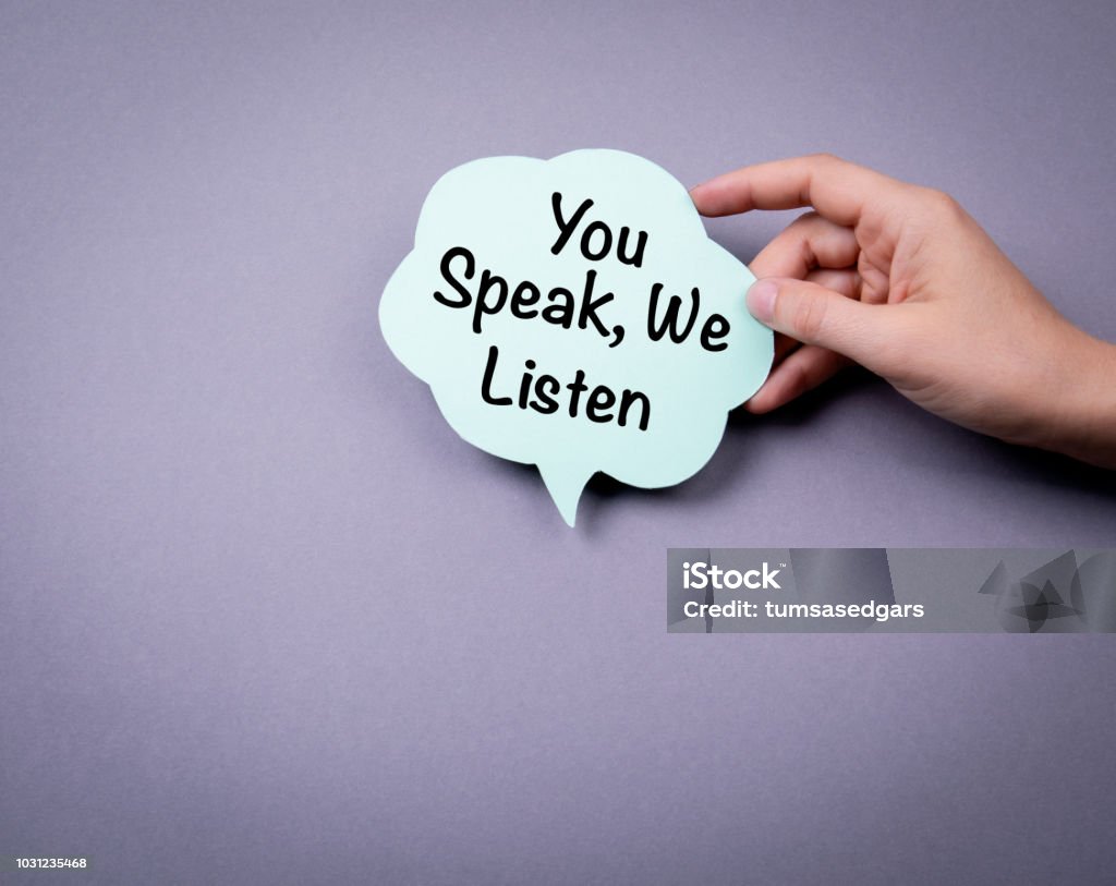 You speak, we listen You speak, we listen. Speech bubble on a gray background Listening Stock Photo