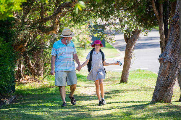 istock Grandparent walking child to school 1031237930