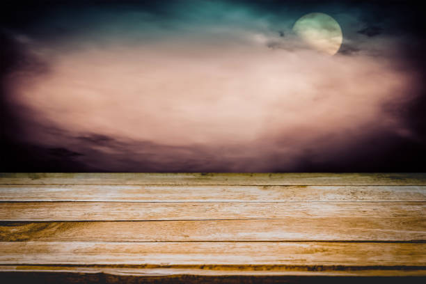 Old wooden table with dark horror background