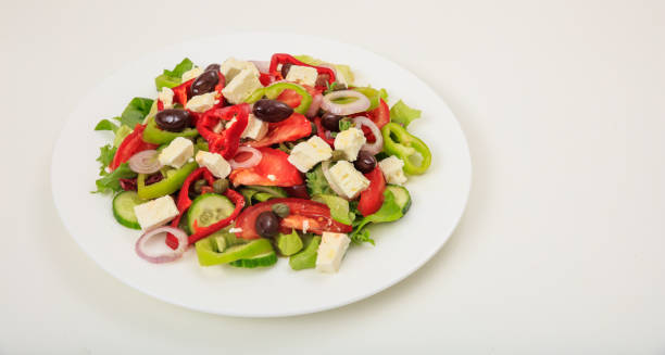istock Greek salad on white background 1031251540