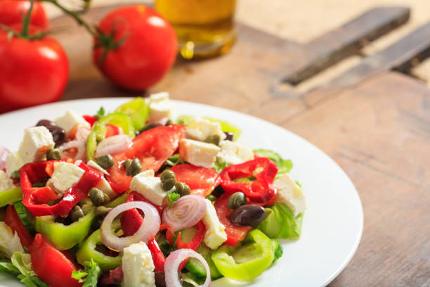istock Greek salad on wooden background 1031251596
