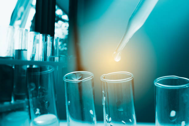 Liquid drop to test tube on blue background.