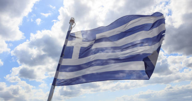 istock Greece waving flag on blue sky. 1031254470