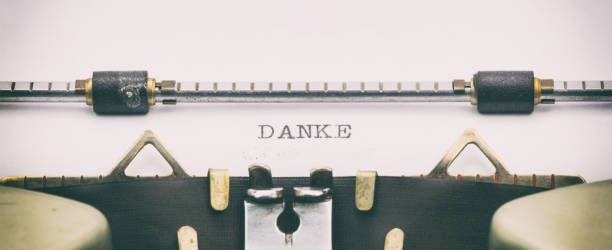 istock Danke word in capital letters on white sheet 1031254720