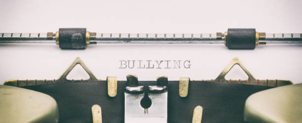 istock Bullying word in capital letters on white sheet 1031254780