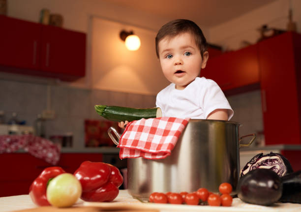 istock baby girl with fresh vegetables 1031257932