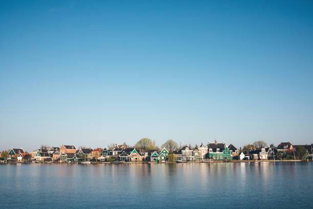 Traditional colorful houses reflecting in Zaan river (Zaandijk, The Netherlands).