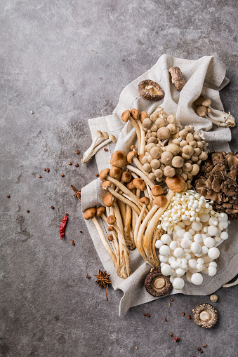 A basket of porcini mushrooms on a wooden background, close up. Ukraine