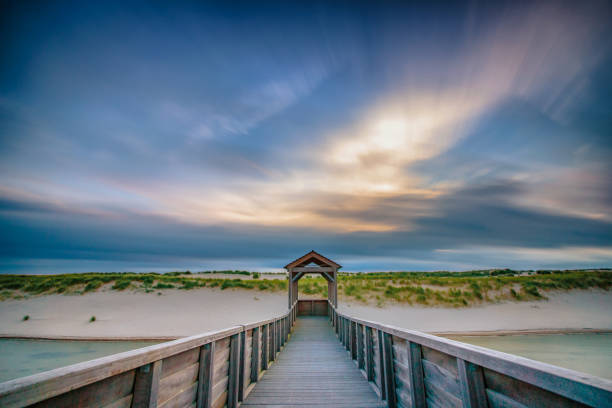 istock Architecture and art along the Dutch coast with beautiful sunset and threatening clouds along the beach and the dunes 1031285270