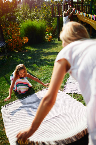 istock Mother and daughter spreading picnic blanket 1031292004