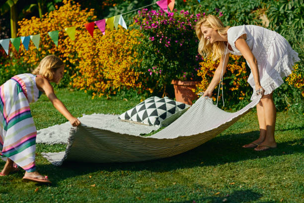 istock Mother and daughter spreading picnic blanket 1031292188