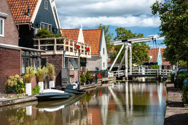 Photo of Typical dutch white wooden drawbridge. Architecture for over channels, ditches or rivers in old villages or cities