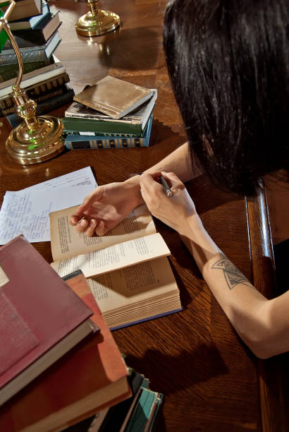 istock girl with books in the library 1031294828