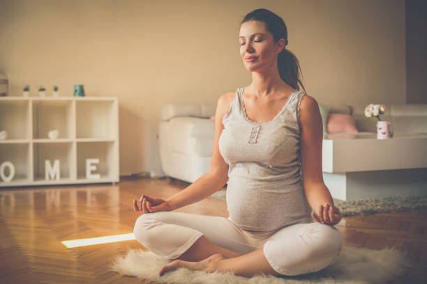 Future mother exercise yoga. stock photo