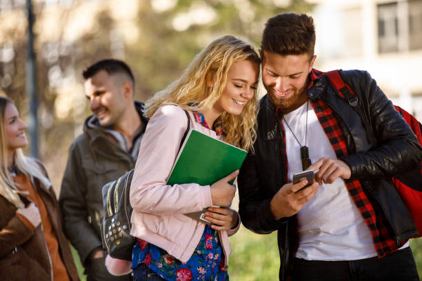 istock College students using mobile phone outdoors 1031303136