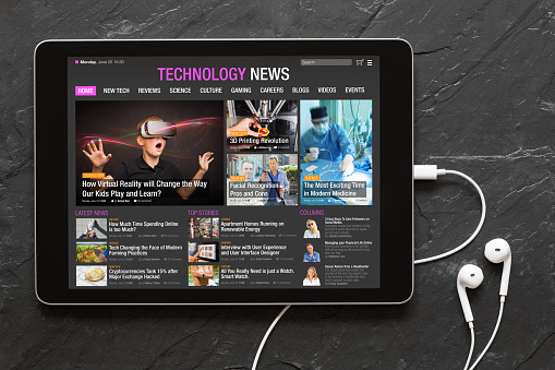 Close up photo of tech news website on tablet. All contents are made up.