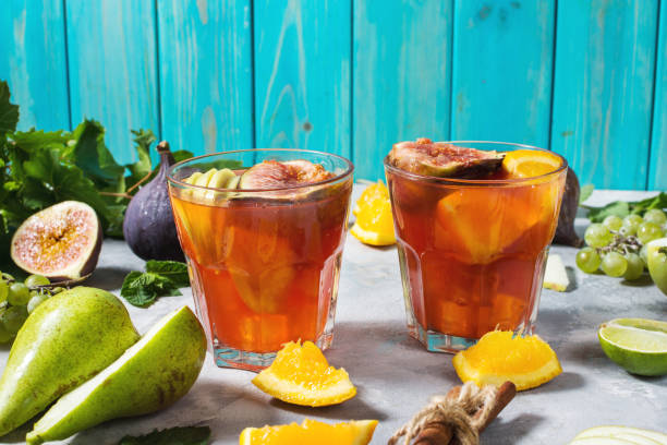 istock Cocktail fruit sangria with apples, orange, figs, grapes on concrete table 1031313716
