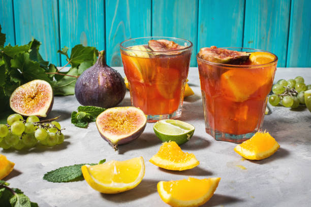 istock Cocktail fruit sangria with apples, orange, figs, grapes on concrete table 1031314170