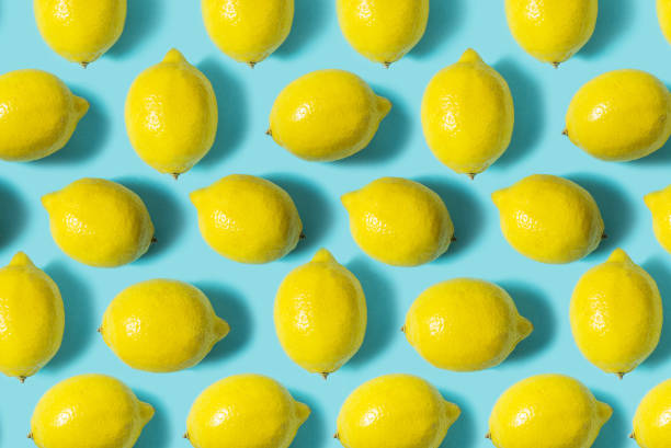 istock Top view of fresh lemon isolated on blue background. Fruit minimal concept. 1031316456