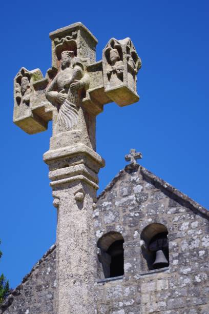 istock Stone cross set up in front of a medieval church. 1031316630