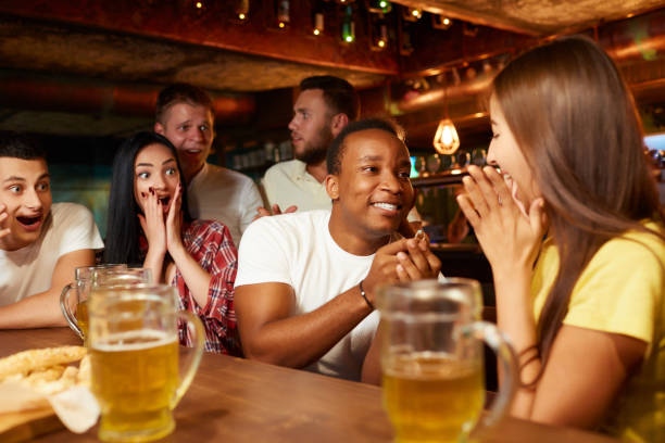 istock Man surprisingly proposing beautiful girlfriend to marry him in bar. 1031317538
