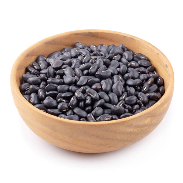 istock Black bean in a wooden bowl isolated on white background 1031321286