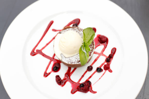 istock Chocolate muffin with vanilla ice cream and berry fruit 1031332974