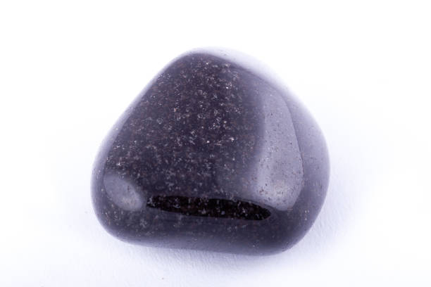 istock Macro mineral stone black Onyx on white background close up 1031333556