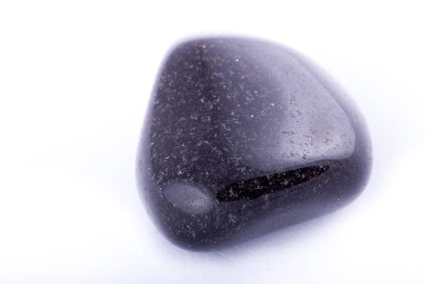istock Macro mineral stone black Onyx on white background close up 1031333578
