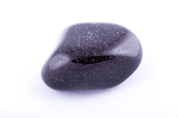 istock Macro mineral stone black Onyx on white background close up 1031333590