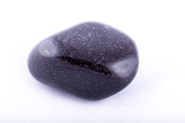 istock Macro mineral stone black Onyx on white background close up 1031333604