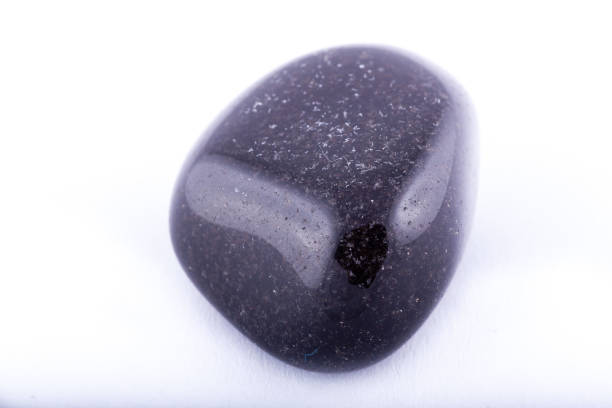 istock Macro mineral stone black Onyx on white background close up 1031333614