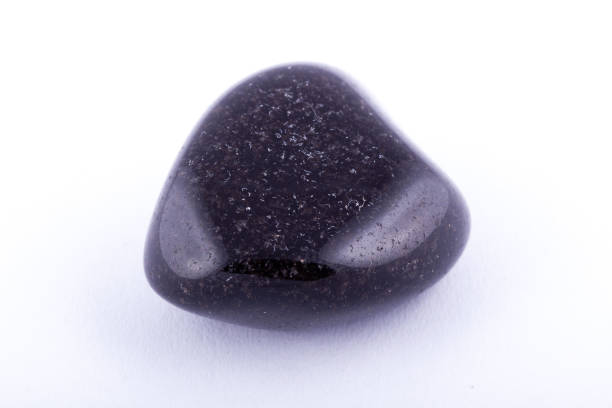 istock Macro mineral stone black Onyx on white background close up 1031333622