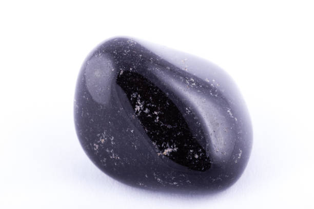 istock Macro mineral stone black Onyx on white background close up 1031333648