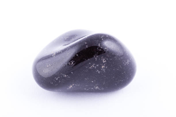 istock Macro mineral stone black Onyx on white background close up 1031333670
