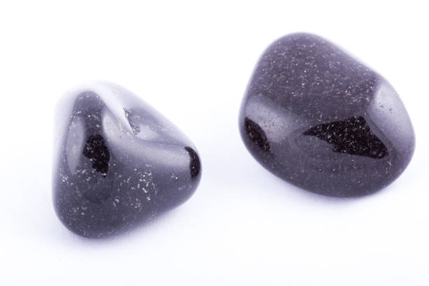istock Macro mineral stone black Onyx on white background close up 1031333702