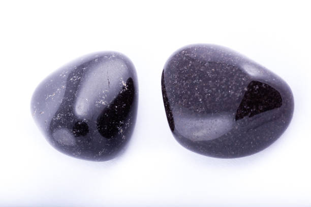 istock Macro mineral stone black Onyx on white background close up 1031333718