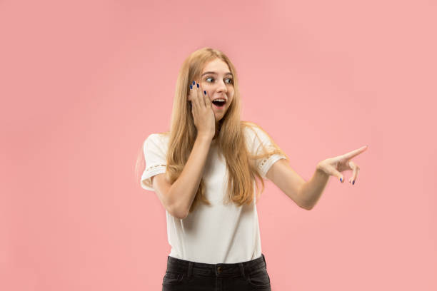istock Beautiful woman looking suprised isolated on pink 1031336390