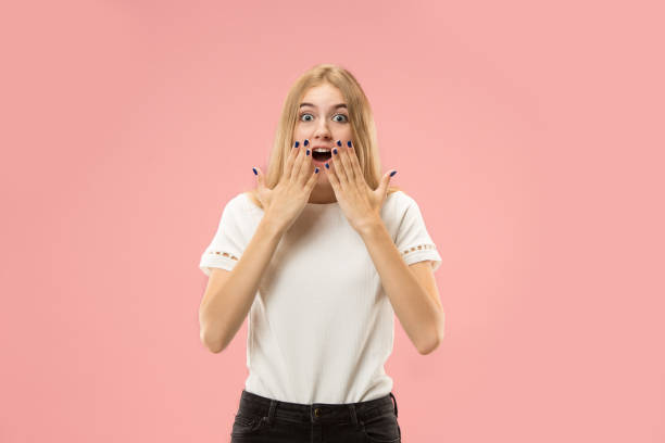 istock Beautiful woman looking suprised isolated on pink 1031336456