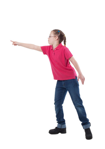 A girl with special needs in profile in full growth indicates something on a white background
