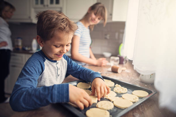 istock Little boy baking cookies with family 1031339722